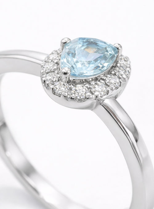 Anillo oro blanco con piedra central agua marina