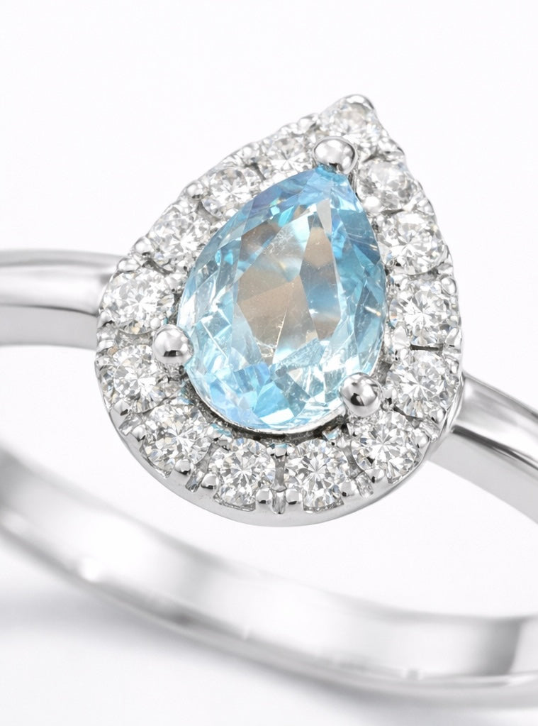 Anillo oro blanco con piedra central agua marina